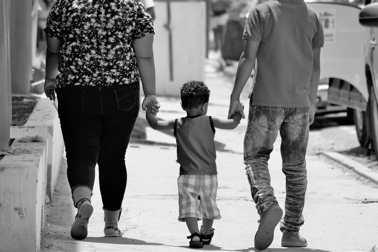 Grayscale Portrait of Man, Woman, and Child Holding Hands